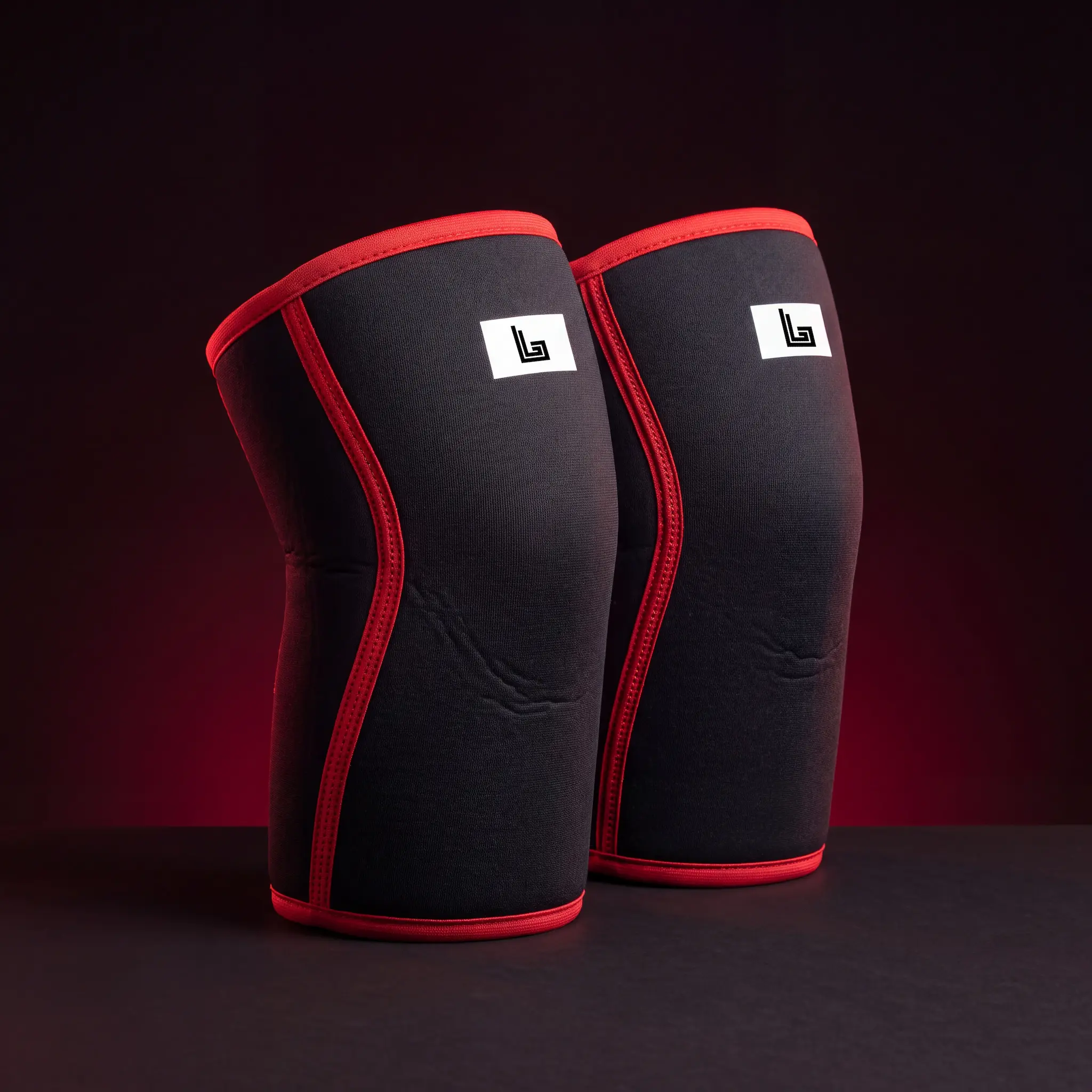 Pair of custom 7mm neoprene knee sleeves with printed gym logo by Lethletic