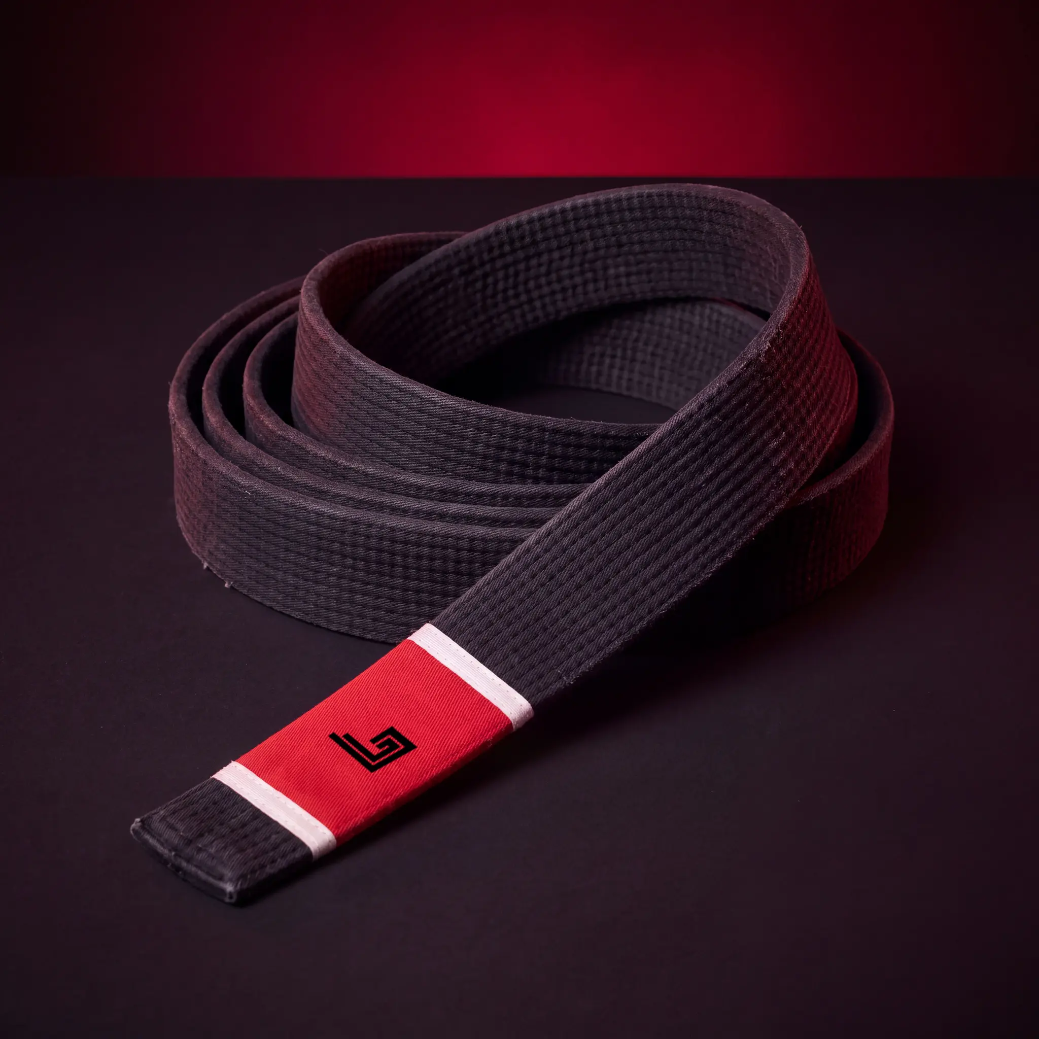 Custom BJJ belt with black rank bar and embroidered academy name
