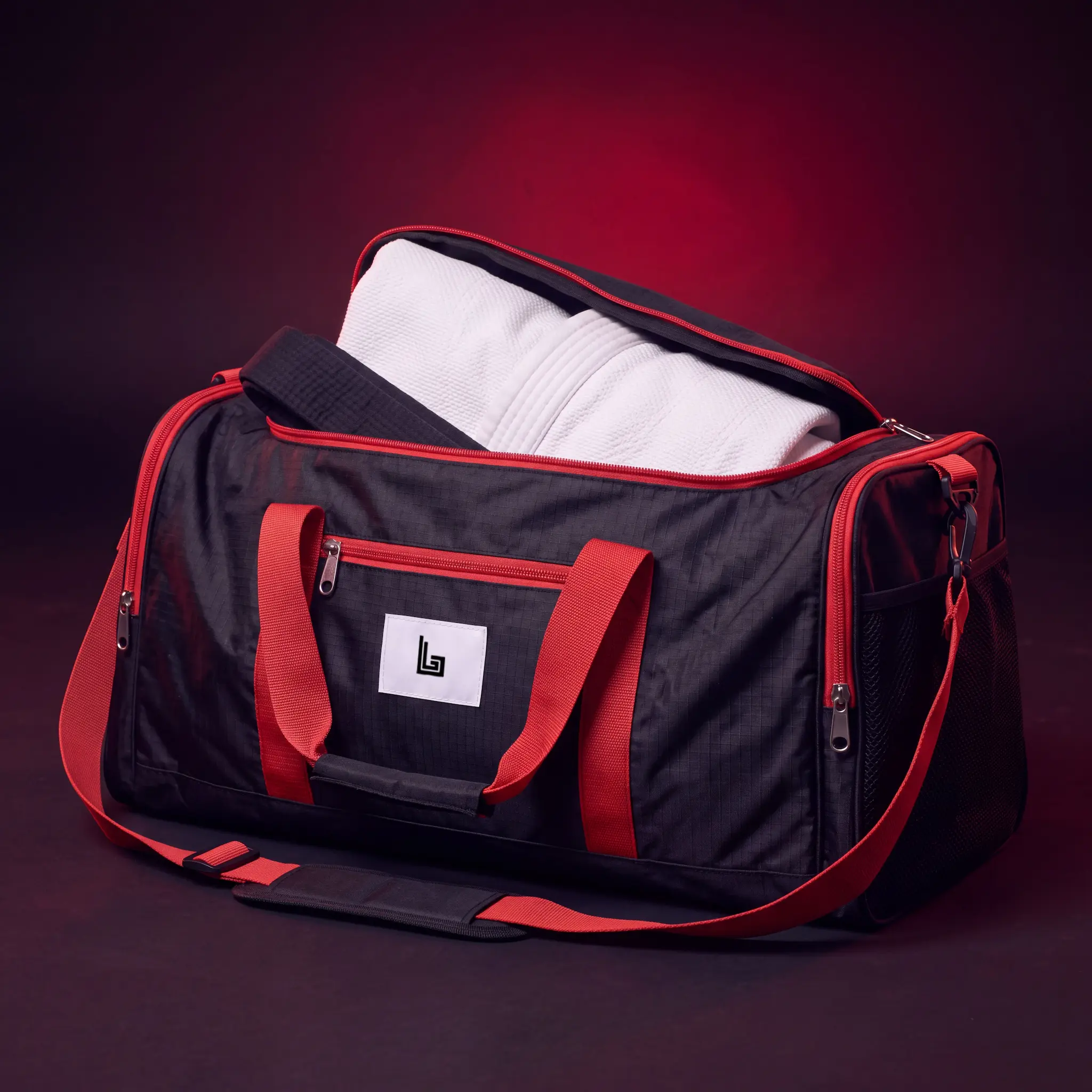Custom BJJ gi duffel bag with embroidered academy logo, ghost mannequin